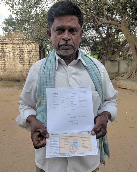 Mahammad with his (orange coloured) October receipt and MRO office print out. The orange receipt was retrived from Mee Seva (‘At your service’), after he was sent back from MRO office. The reciept acknowledges the request to add his name back onto his family’s ration card. The white print is given by operator at MRO office, which says "..uid already exist in the..". The photo was taken outside the MRO office after we got the white print out