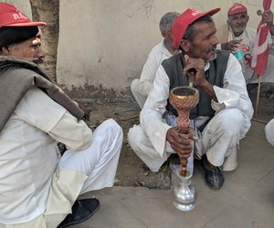 Farmers taking a hookah break while marching; they had brought along their pipes from their villages.