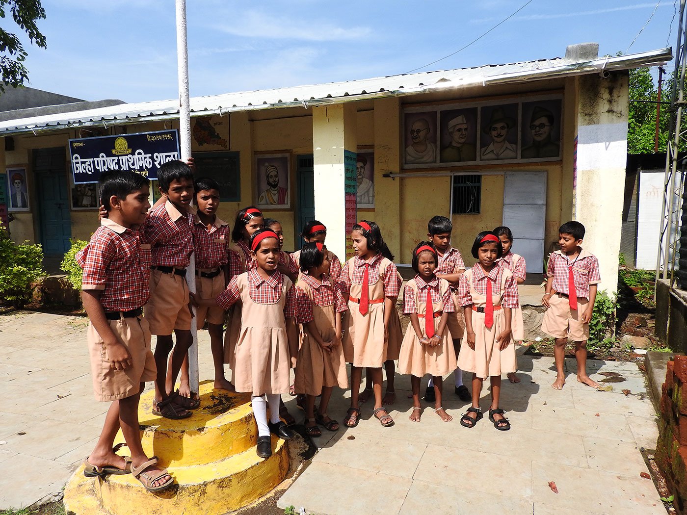 Children singing outside a school.