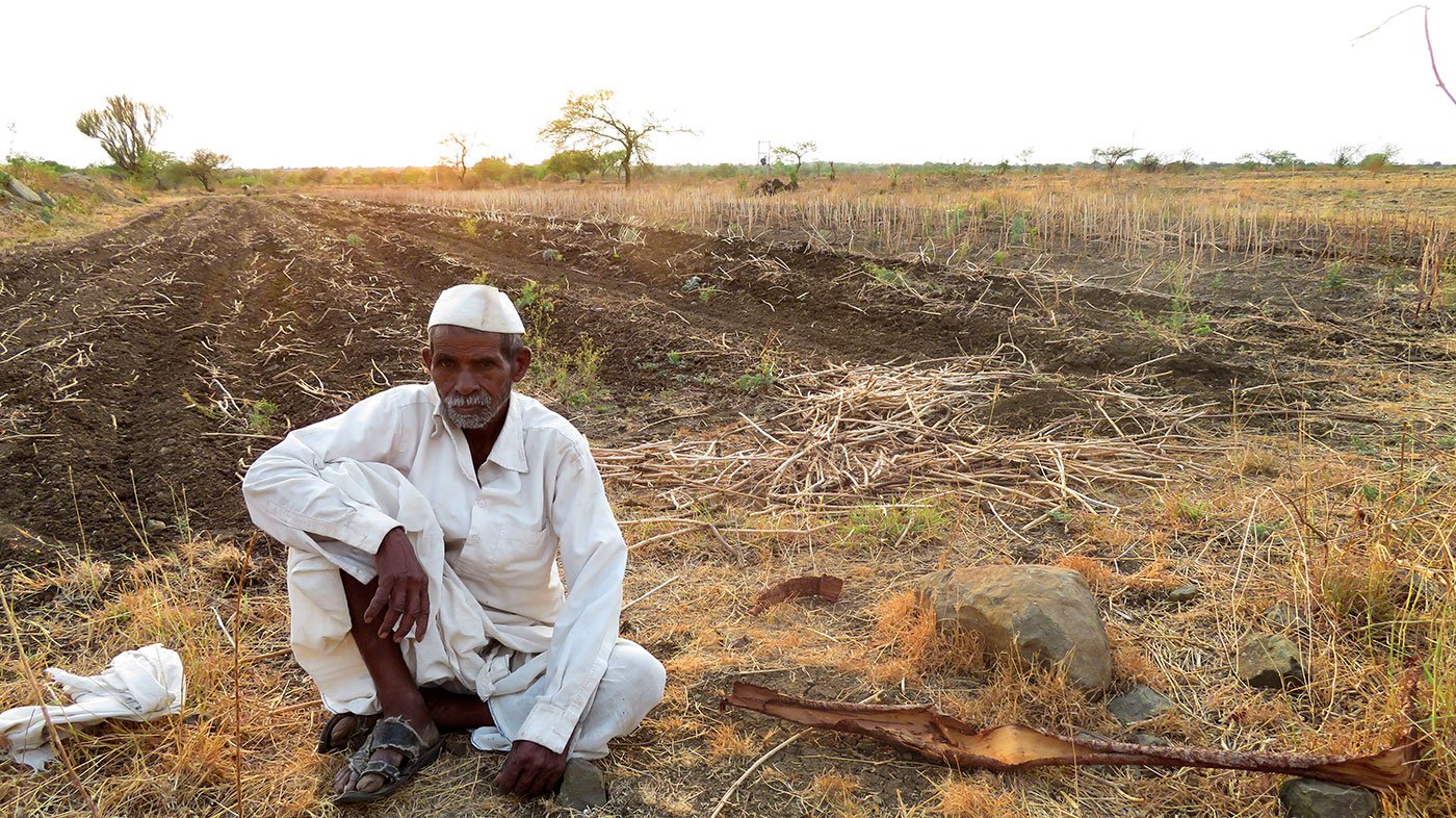 farmer sitting beside his land