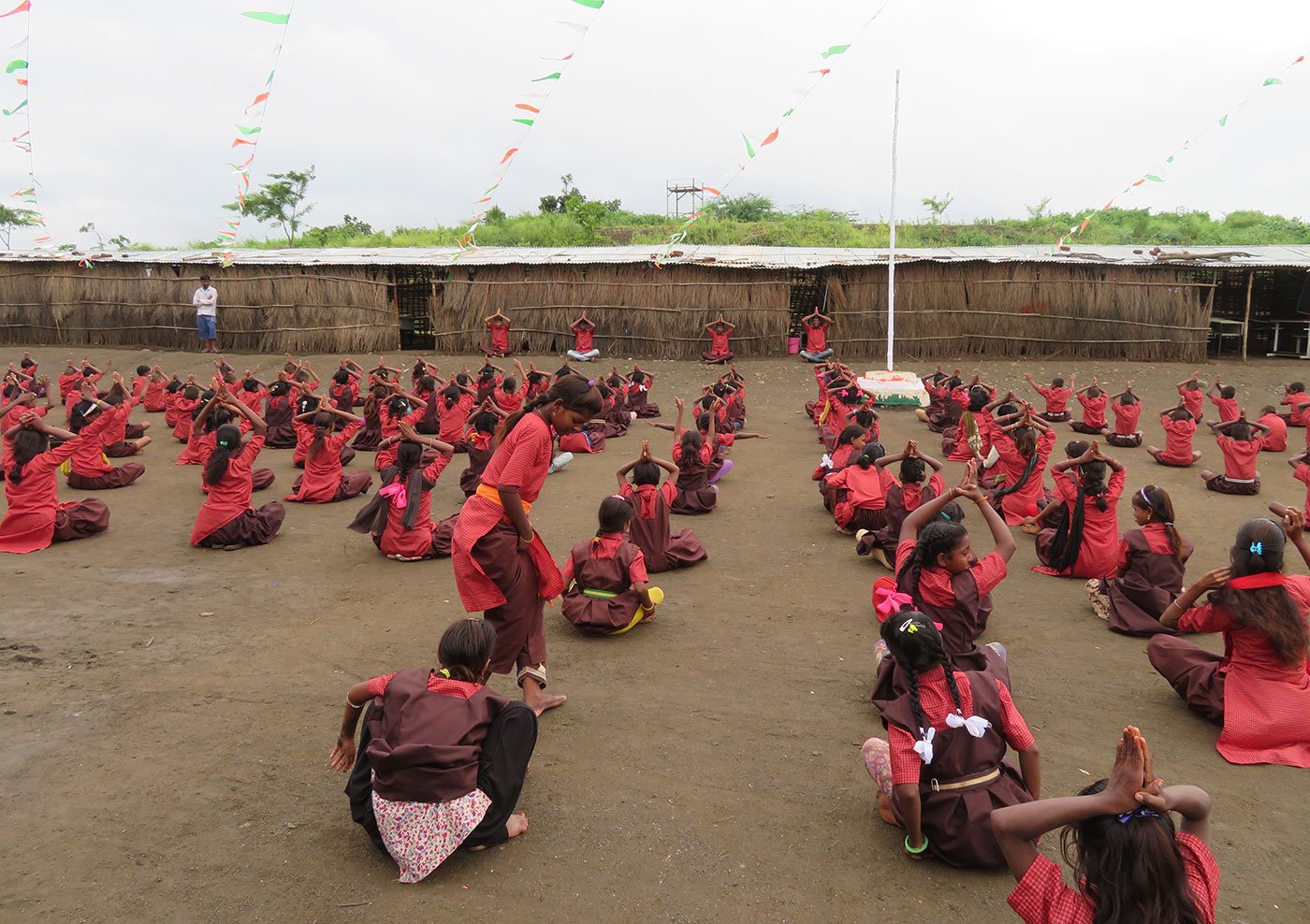 Students of Phanse Pardhi School exercising on the school grounds
