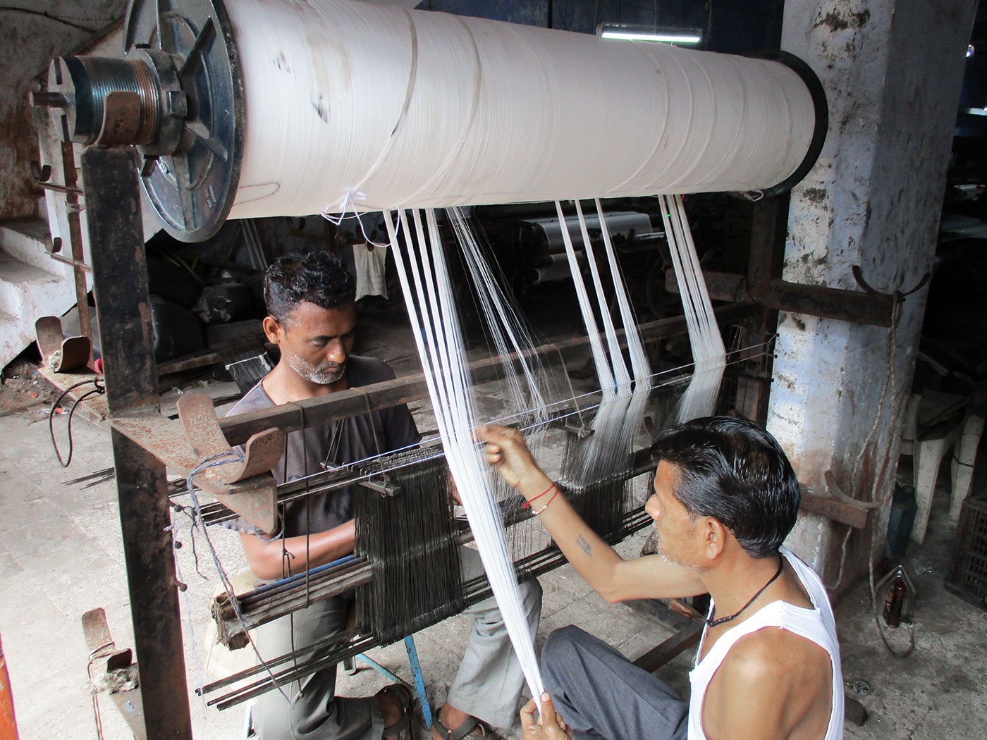 Workers toil on the beem-pachaad (rolling pin) machine in a unit on Ved Road. The workers earn a daily wage of Rs 250-Rs 300 after toiling for 12 hours
