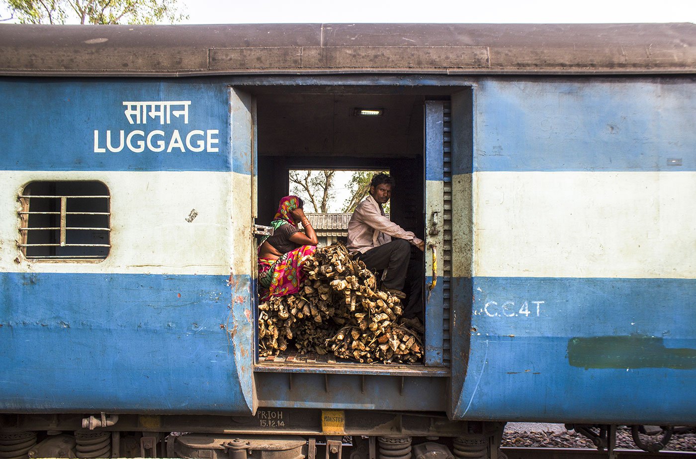 An Adivasi couple travelling with their firewood