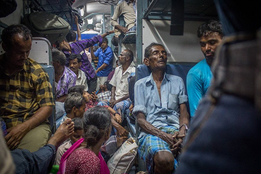 Exhausted migrants on the Kochi-Kadiri train