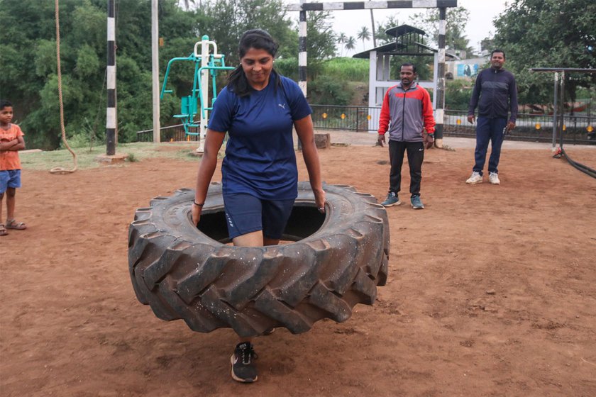 An athlete carrying a 200-kilo tyre for her workout