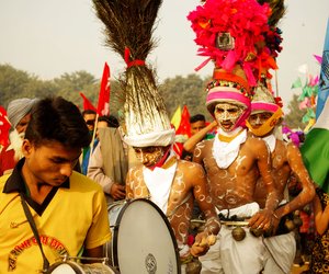 Dancers from Nandurbar district in Maharashtra in traditional Bhil and Pawra Adivasi attire, drums and chiming bells.