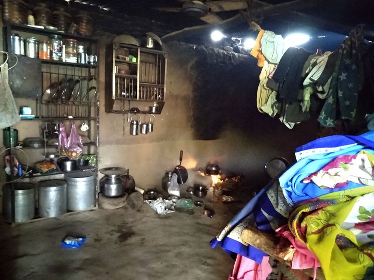 The inside of a hut with utensils and clothes