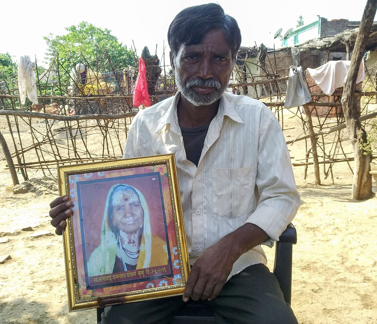 Subhash Ghosale, a tribal farmer in village Borati, holds the photo of her mother Sonabai Ghosale, T1’s first victim. She died in T1’s attack on her field close to the village on June 1, 2016