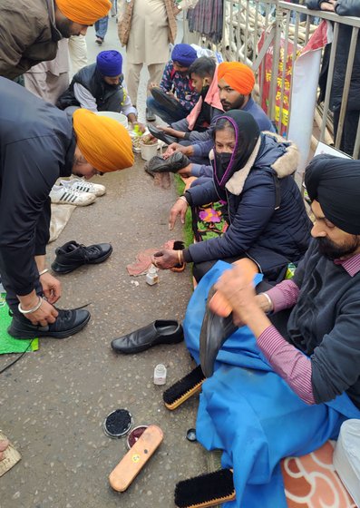 'I cannot usually sit for one hour straight. But once we come here, I clean shoes for six hours and feel no pain while doing so,' says Jaswinder, who suffers from chronic back pain. 'I am a daughter of farmers. I cannot see them in pain. I polish their shoes', says Prakash