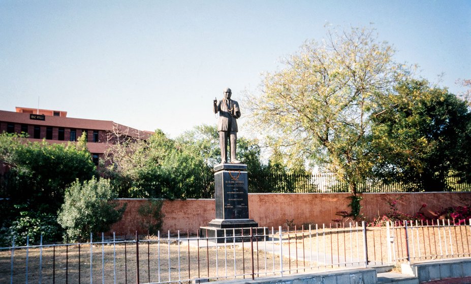 An Ambedkar statue stands at the street corner facing the traffic
