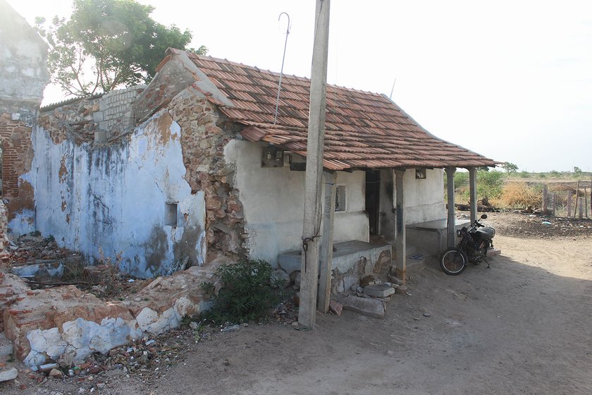 Kandasamy's home with his two wheeler parked in front of it   