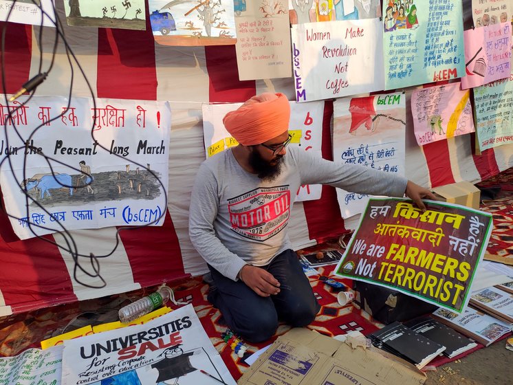 A farmer making placards at the protest site
