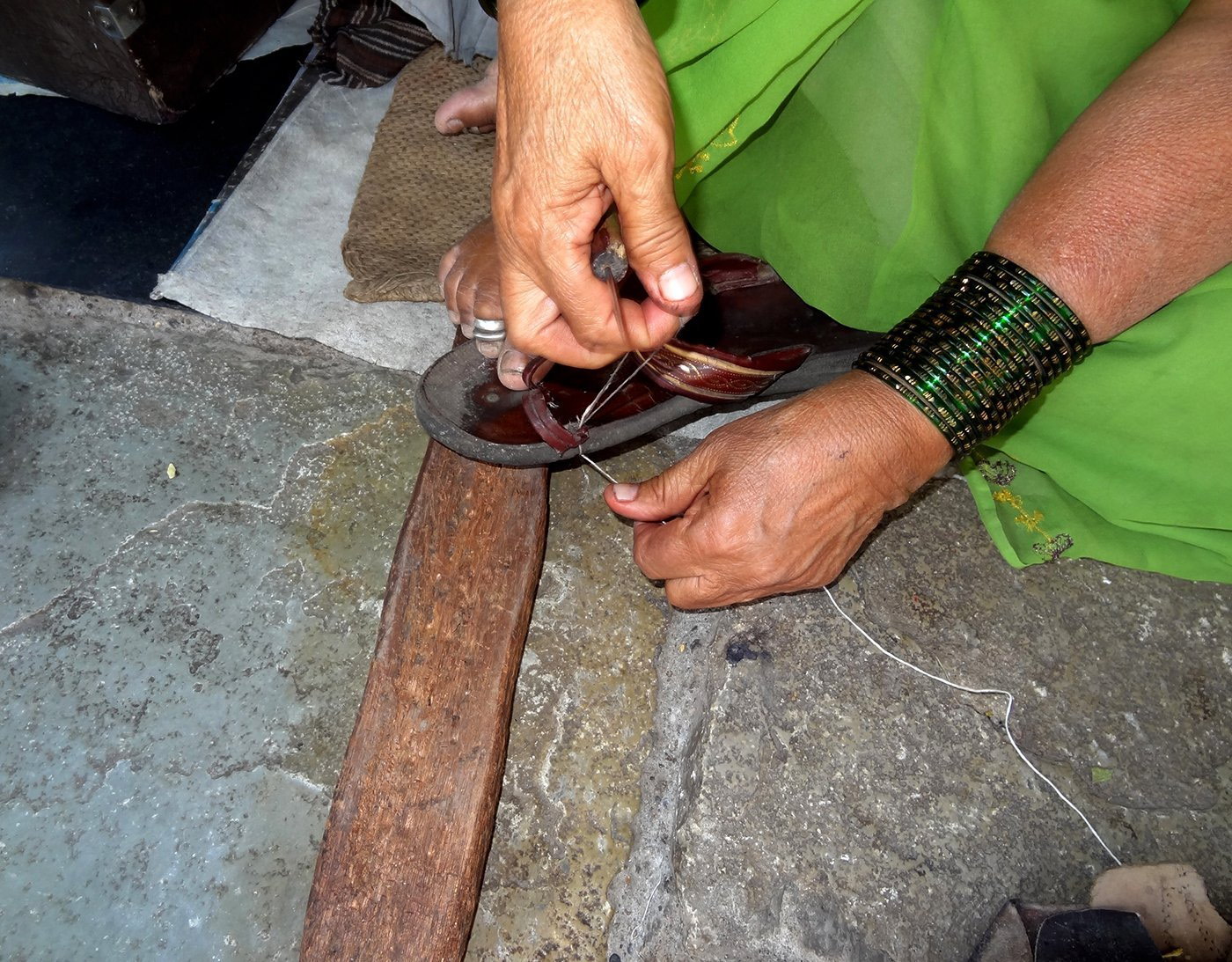 03-Bhamabai_Stitching_DSC01555-NW-Fixing Straps and Mending Soles.jpg