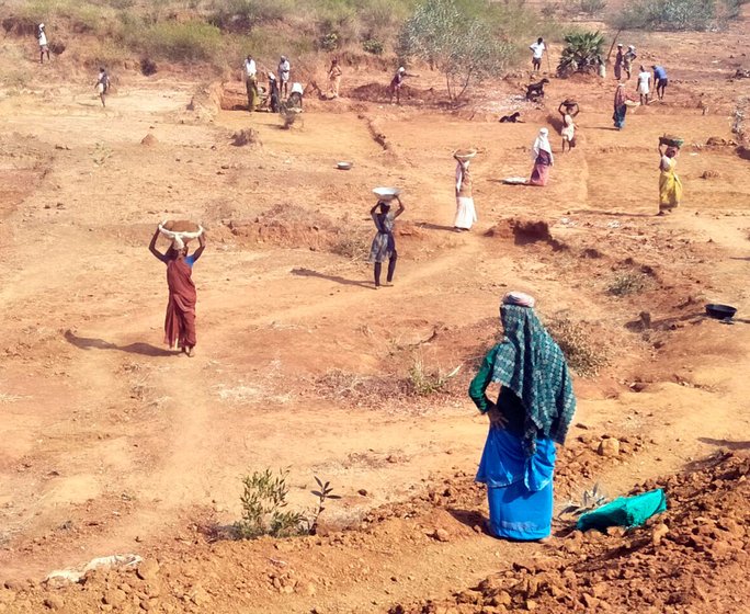 Labourers working in MGNREGA work sites on the outskirts of Munagapaka village 