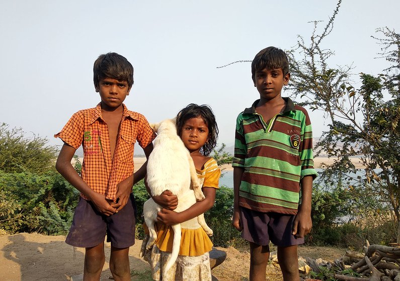 Prashanth, Smiley and Bharath (Left to Right) in front of their house along with their pet, Snoopy