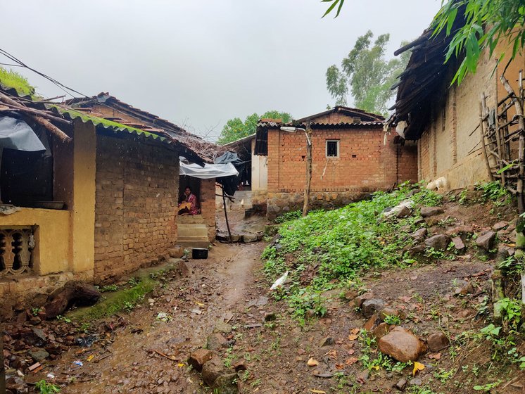 The lane to Dilip's house (left) in Kadvyachimali hamlet (right), with houses whose residents migrate for work every year

