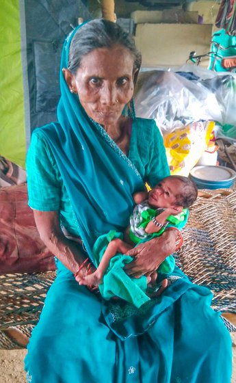 Geeta (left), holding her neighbour’s one month old baby, Rinky, who she ran to rescue first when the Yamuna water rushed into their homes near Mayur Vihar metro station in July this year.