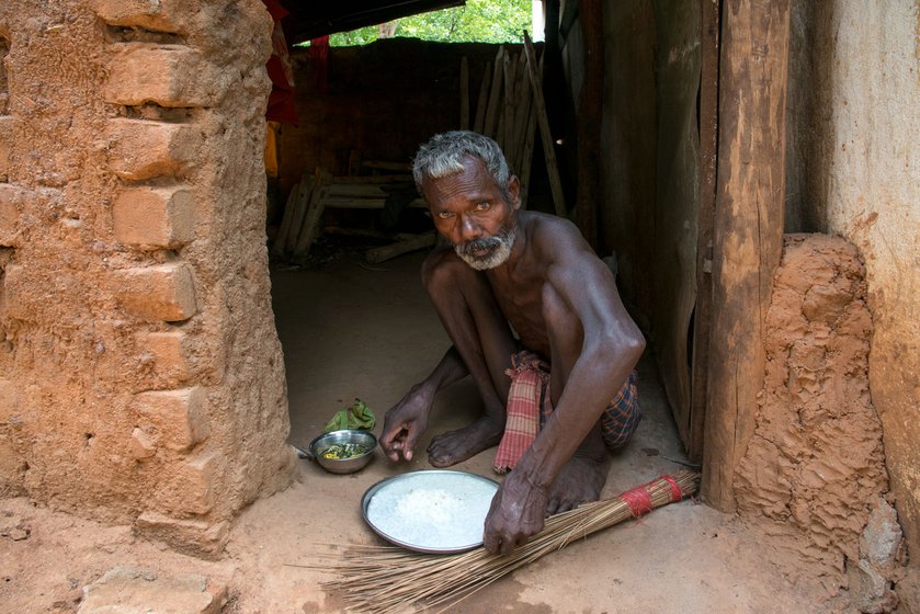 A resident of Tapoban village, Bankim Mallick (left) is eating panta bhaat (fermented rice), a staple for many families who cannot afford to buy food. The fear of wild animals has made them wary of finding food in the forest.