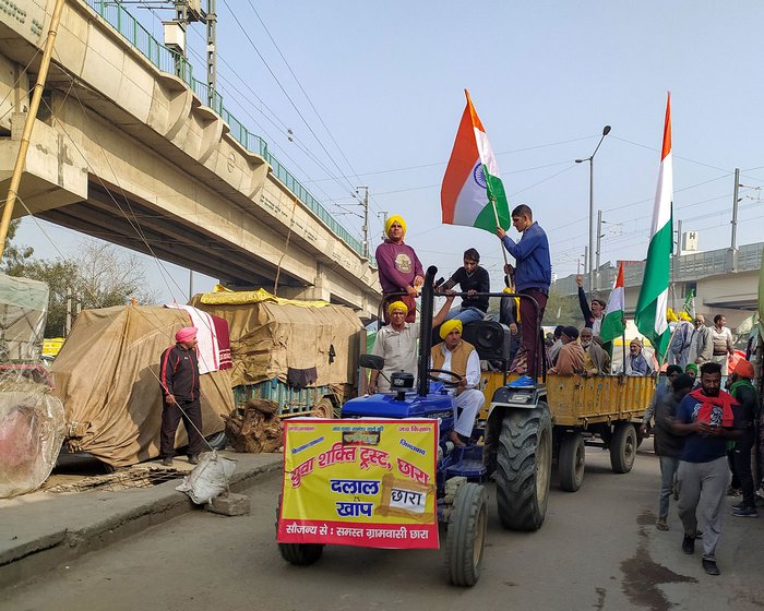 Left: A convoy of truck from Bathinda reaches the Tikri border. Right: Men from Dalal Khap preparing for the tractor parade