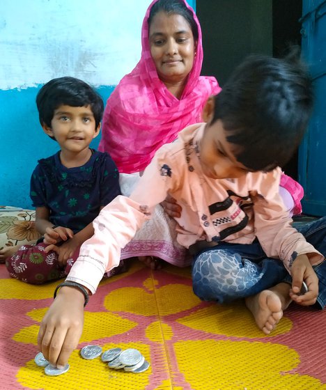 Moulding tokens is a family tradition: Azeem's wife Nazima (centre) would pitch in when they had a furnace at home. His father (right) was a master craftsman