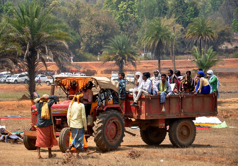 People sitting in a tractor to participate in Jatra