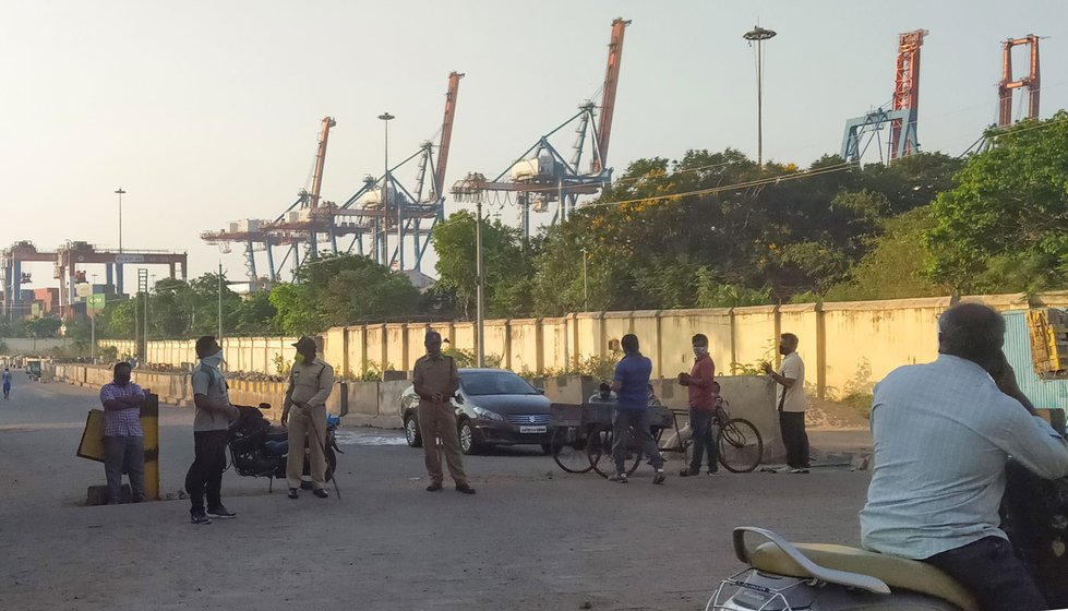 Left: The Fishing Harbour in Visakhapatnam (file photo). As of April 2, 2020, fishermen were officially not allowed to venture out to sea. Right: The police has been guarding the entrance to the jetty and fish market during the lockdown

