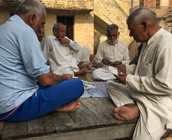 Only men occupy the chaupal at the village centre in Harsana Kalan, often playing cards. 'Why should women come here?' one of them asks