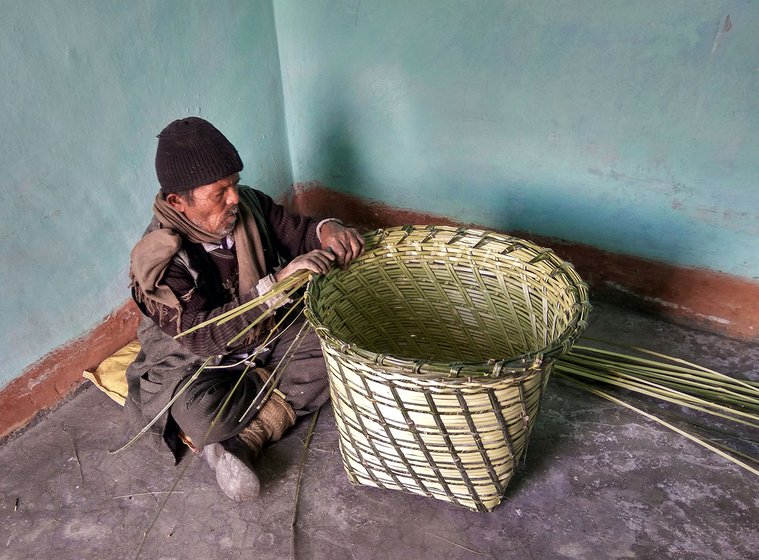 The man has finished weaving his basket