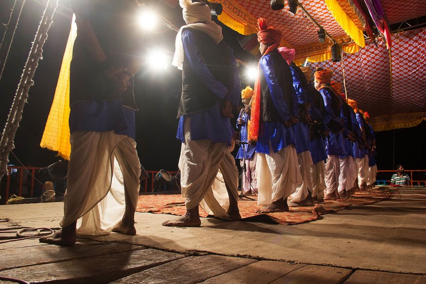 Male artists take position for the gan during the performance in Gogolwadi village, Pune district