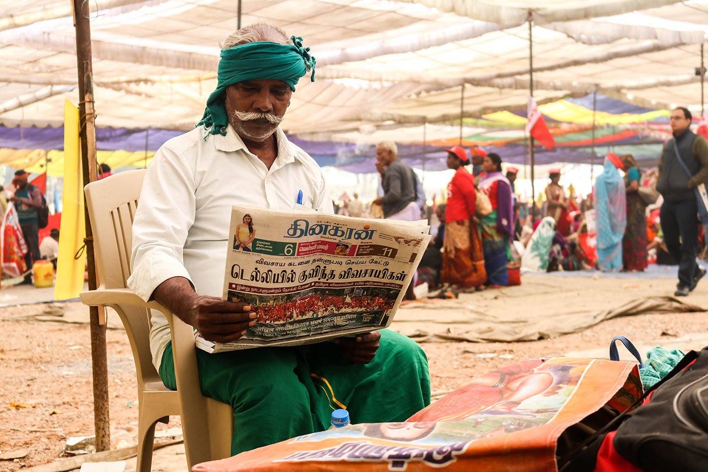 Kodanda Raman, 62, a farmer from Kanjankollai village in Kattumannarkoil taluka of Cuddalore district in Tamil Nadu reading the Tamil Newspaper to see if they had covered their story on the March towards Ramlila Maidan