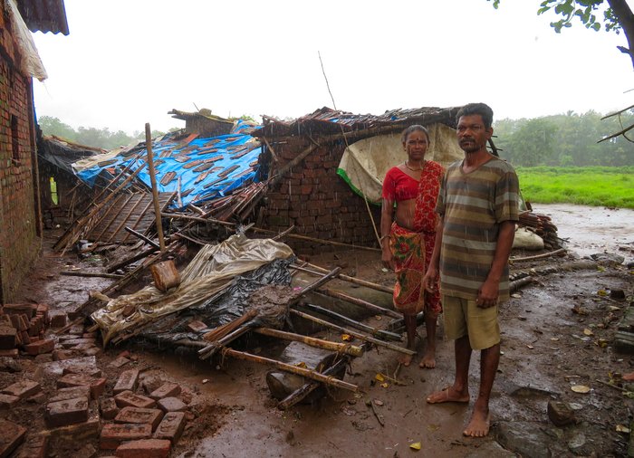 Bala and Gauri Wagh outside their rain-damaged home in August 2019 