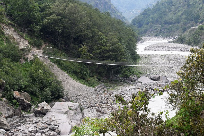 A footbridge hangs connecting the two nations of Nepal and India.