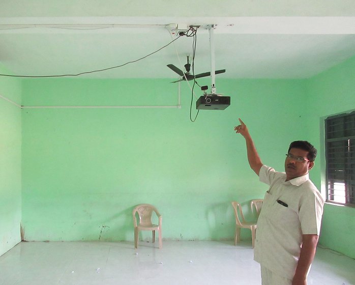 Bashir Tamboli pointing to projector that can't be used