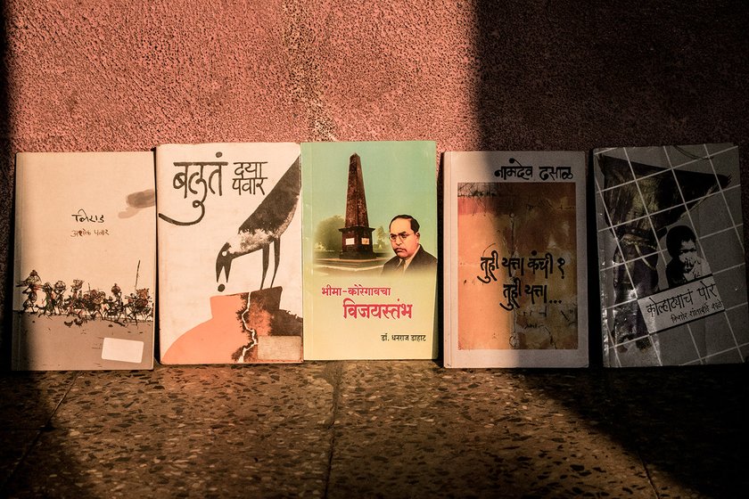 Books on Dalit literature lined up against a wall