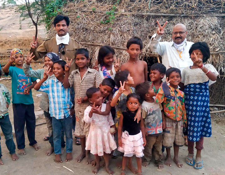 Left: A file photo of Tatwashil Kamble with a few homeless children. Right: Kamble and Ashok Tangde (right) at a Pardhi colony in Beed after distributing ration kits