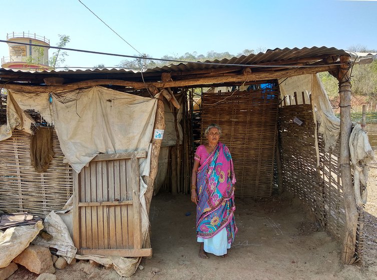 Rapaka Devaschamma, mother of Rapaka Venkatesh, in front of the house she constructed with bamboo in the Resettlement Colony of Pydipaka. The government is supposed to give her a concrete house but hasn't given one till date.