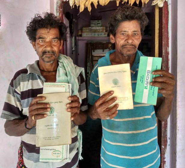 Bantu Durga Rao and Yagati Asrayya with their passbooks in front of Durga Rao's house in Kotapalem