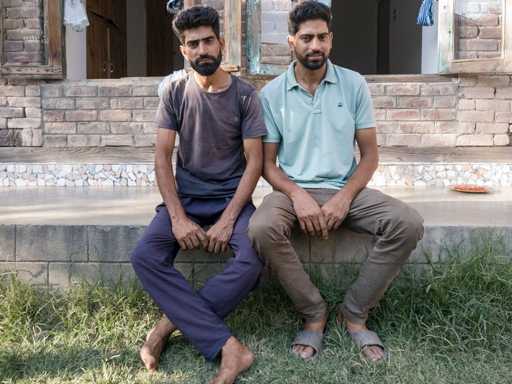 'In Dal, except tourism, we can't do much,' says Shabbir Ahmad (sitting on the right), now working on the lake’s de-weeding project with his brother Showkat Ahmad