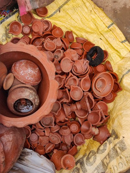 Machine-made diyas washed and kept to dry outside a house in the same locality
