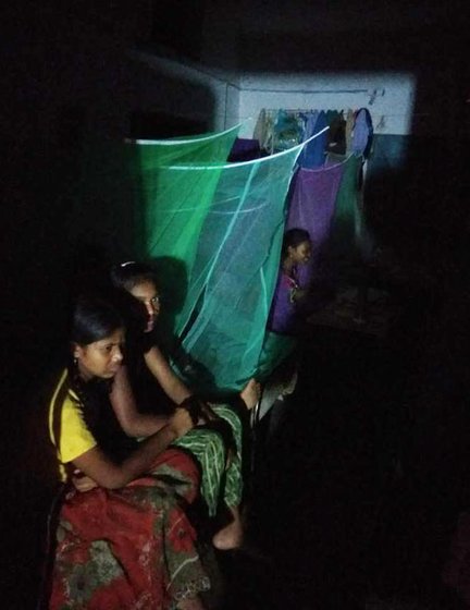 Girls in a residential hostel in Farsegarh singing softly with the lights switched off, after school hours 