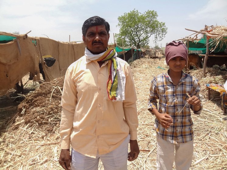 Prahlad with his youngest son Vijay, a seventh grader, at the cattle camp