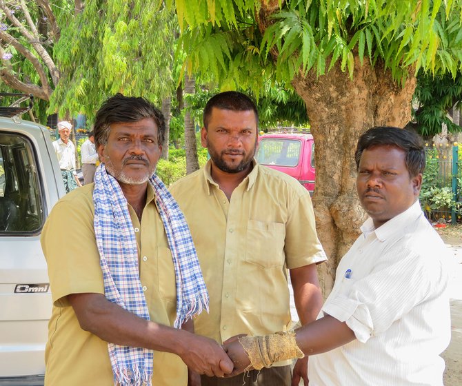 Puttanna (left) and Manjunath (middle) have been working as manual scavengers, an illegal occupation, for 11 years now. In this photo, they are standing next to Siddhagangaiah (right), a coordinator at Dalit rights group, Thamate.