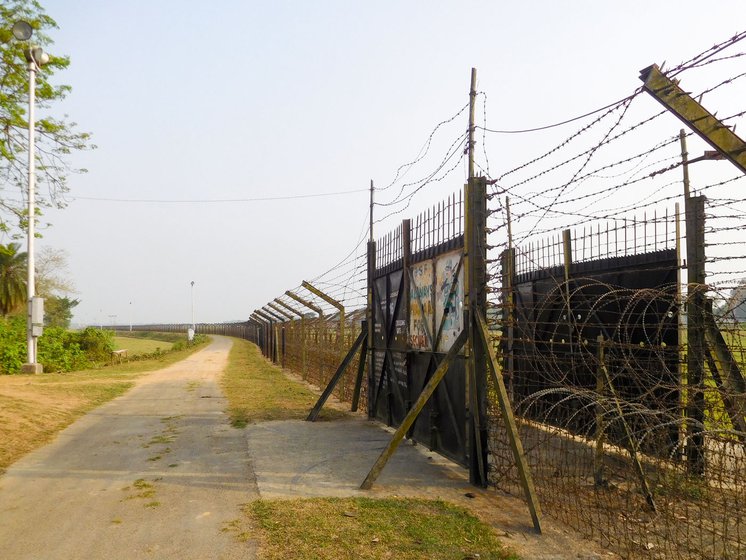 The road and gate at the border on the India side. At times, fights break out when cattle stray across, or straw is stolen or demarcation lines are disputed