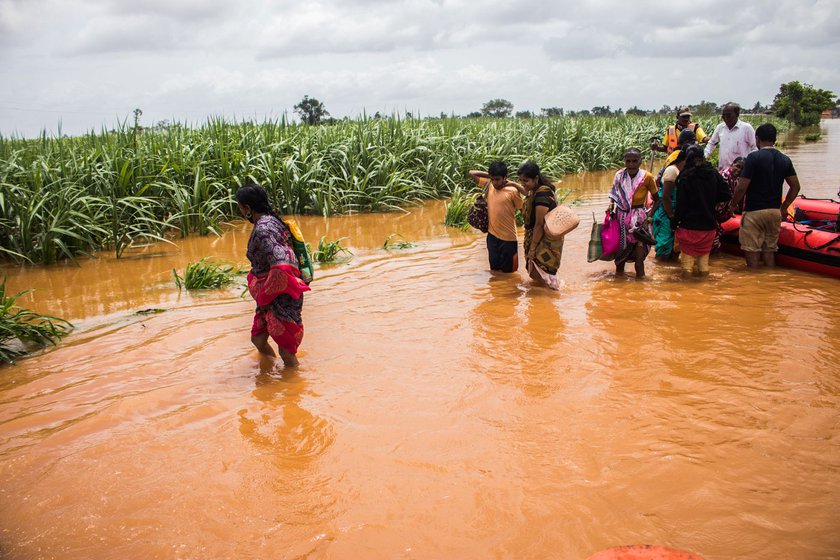 Stranded villagers being taken to safety after the floods