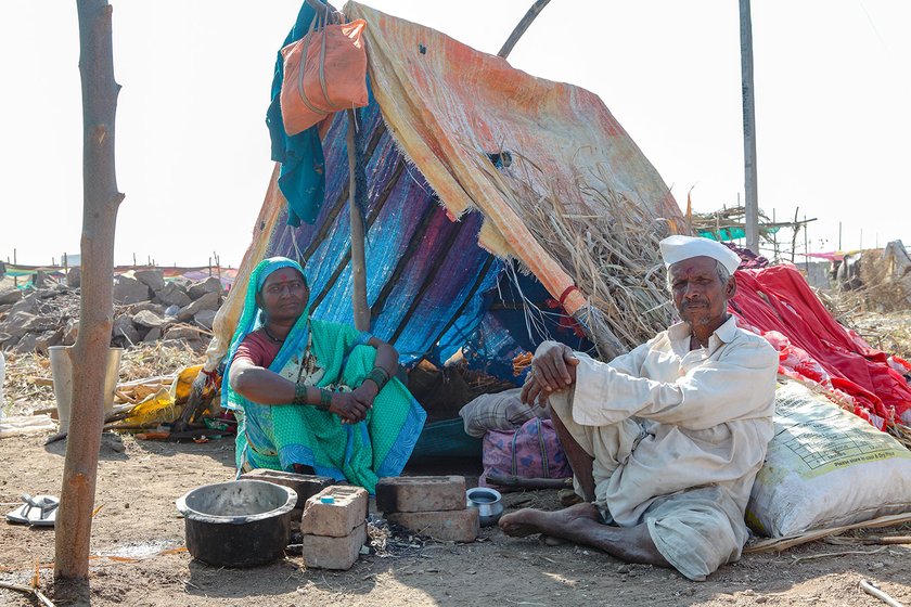 Lakshmi and her husband Paramaeshwar sitting outside her tent