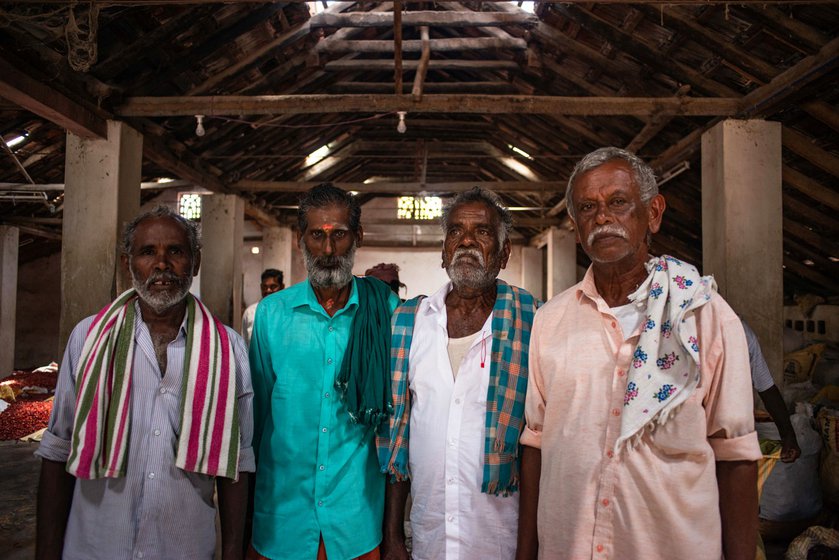 Govindarajan (extreme right) waits with other chilli farmers in the traders shop with their crop