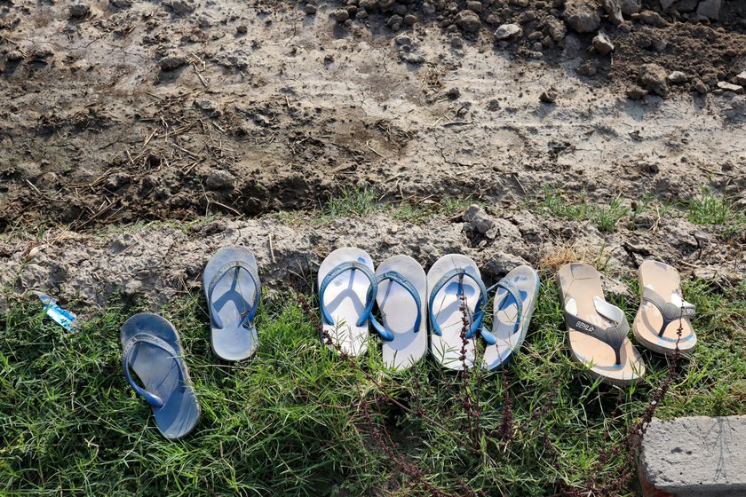 Transplanting paddy is one of the few seasonal occupations available to labourers in this village. As they step barefoot into the field to transplant paddy, they leave their slippers at the boundary