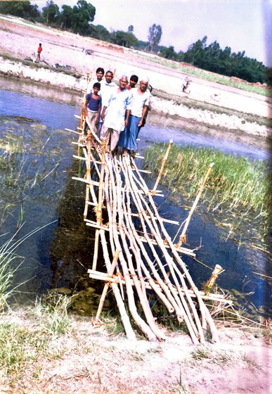 Right: Villagers standing on top of a makeshift bamboo bridge
