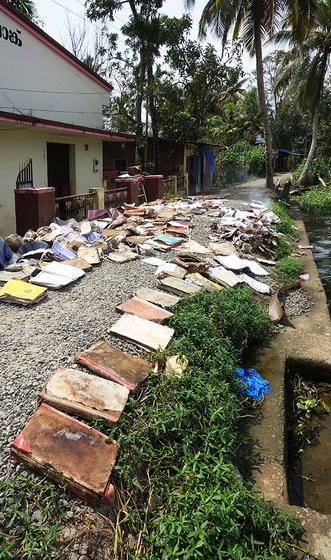 Documents and books drying on the banks of the river outside the bank