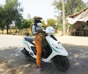 Woman standing with scooter